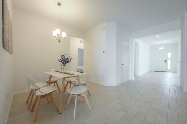 dining room with a chandelier and light wood-type flooring