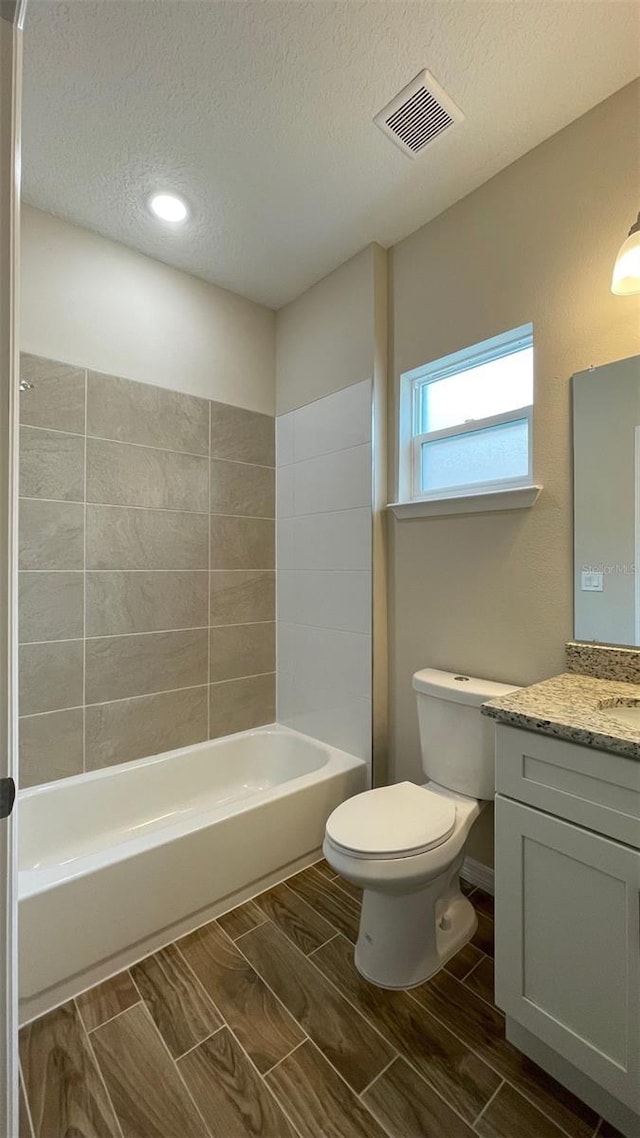 full bathroom with toilet, vanity, shower / washtub combination, and a textured ceiling