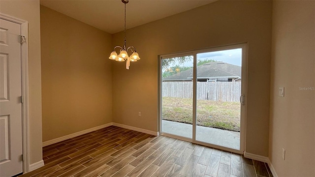 unfurnished dining area featuring a chandelier