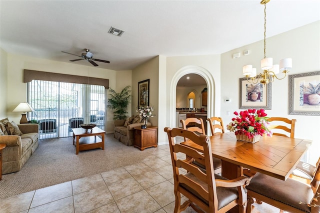 dining room with ceiling fan with notable chandelier and light tile patterned floors