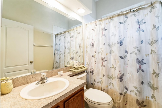 bathroom with toilet, vanity, and a shower with curtain