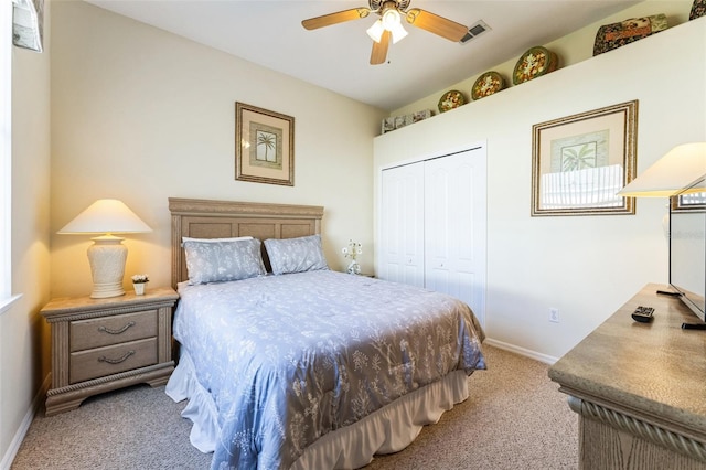 bedroom featuring light carpet, baseboards, visible vents, a ceiling fan, and a closet