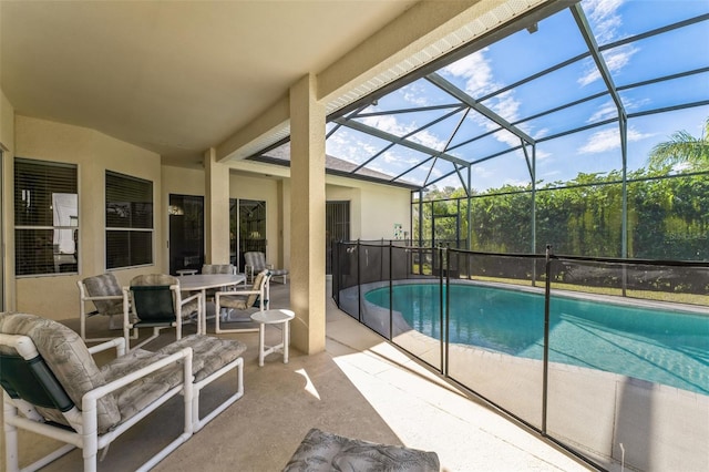 view of pool with a patio area and glass enclosure