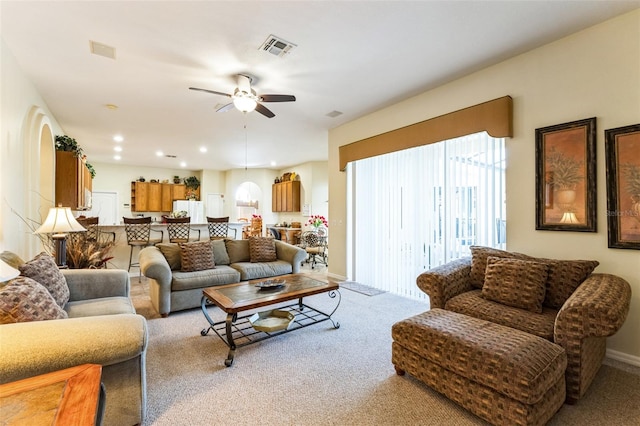 carpeted living area with baseboards, visible vents, a ceiling fan, and recessed lighting