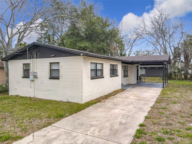 view of property exterior featuring a lawn and a carport