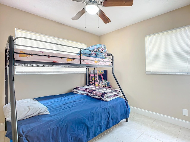 bedroom with ceiling fan and light tile patterned floors