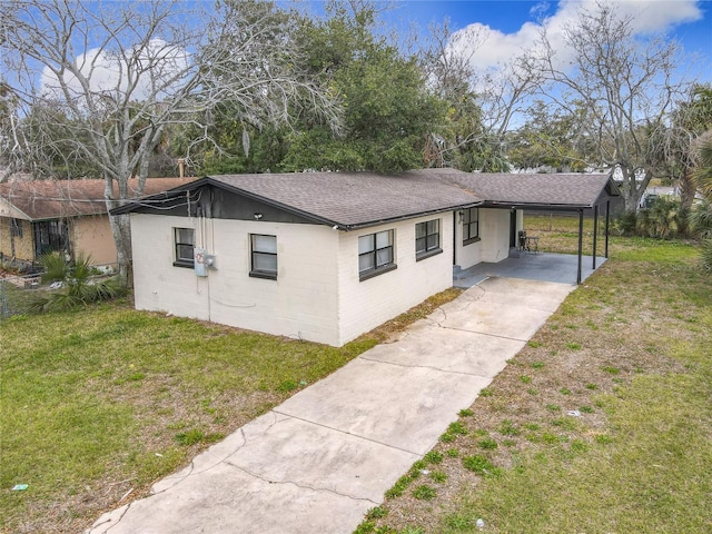 view of side of property with a yard and a carport