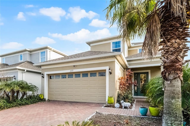 view of front of home with a garage and french doors