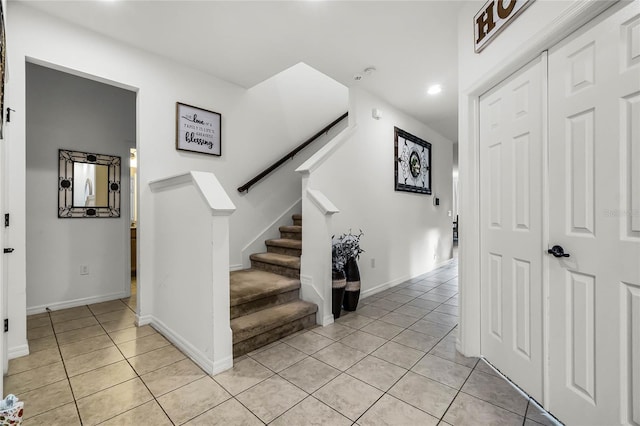 stairway with tile patterned flooring