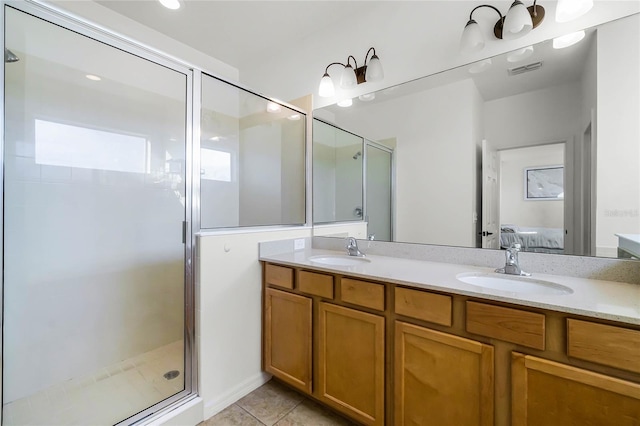 bathroom with vanity, an enclosed shower, and tile patterned floors