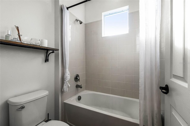 bathroom featuring shower / bathtub combination with curtain and toilet