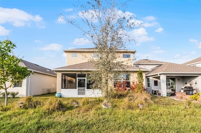 rear view of house featuring a sunroom