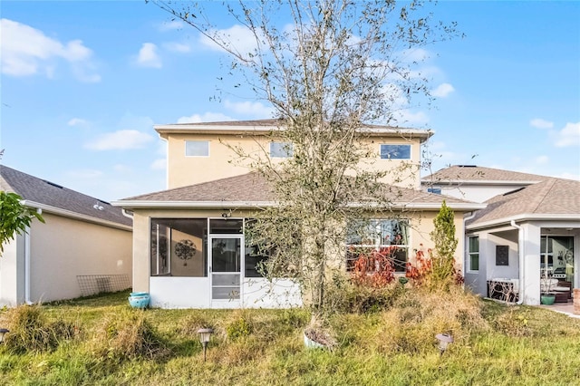 back of house featuring a sunroom