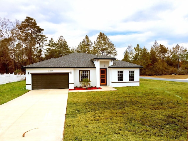 view of front of home with a garage and a front lawn