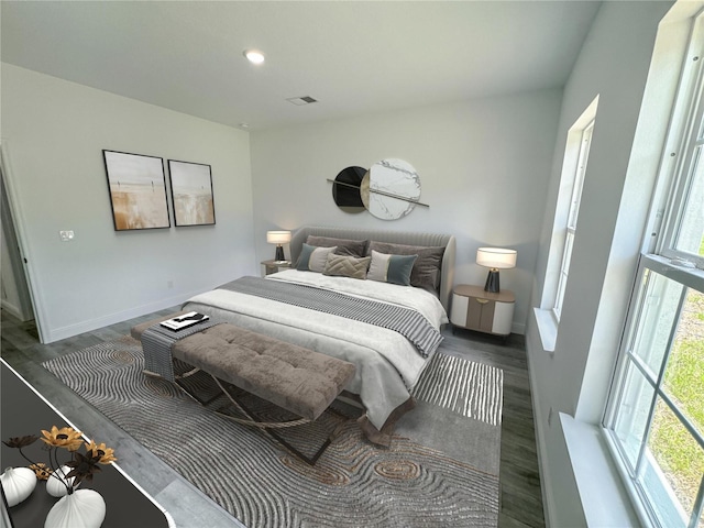 bedroom featuring dark wood-type flooring and multiple windows