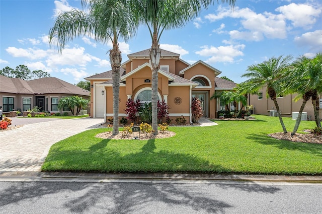 mediterranean / spanish house with a garage and a front yard