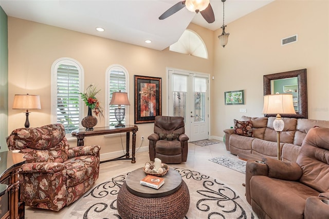 tiled living room with ceiling fan