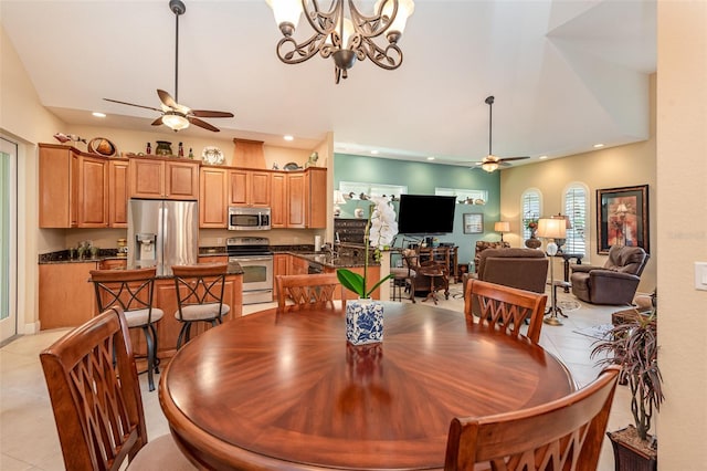 dining area featuring ceiling fan, sink, and light tile patterned floors