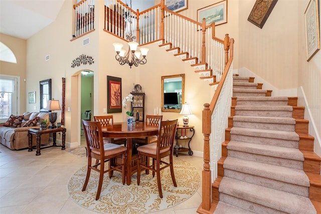 dining room with light tile patterned flooring and a chandelier