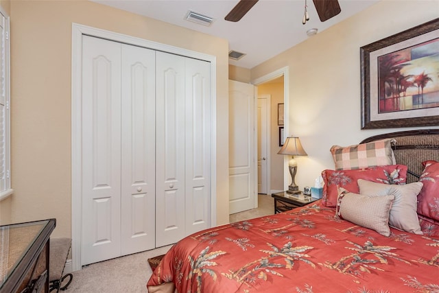 carpeted bedroom featuring a closet and ceiling fan