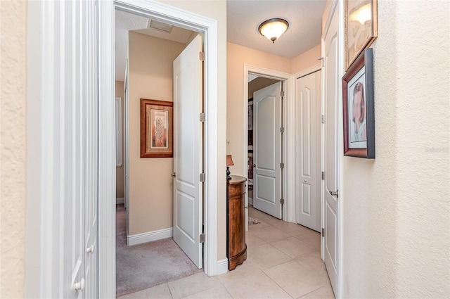 corridor featuring light tile patterned floors