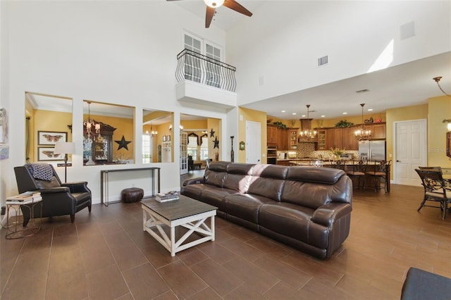 living room with dark hardwood / wood-style floors and ceiling fan with notable chandelier