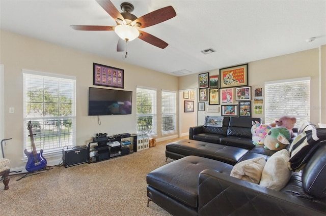 carpeted living room with ceiling fan