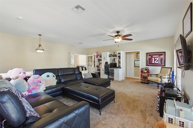 carpeted living room featuring ceiling fan