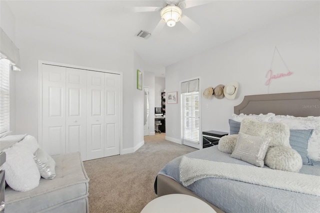 carpeted bedroom with ceiling fan and a closet