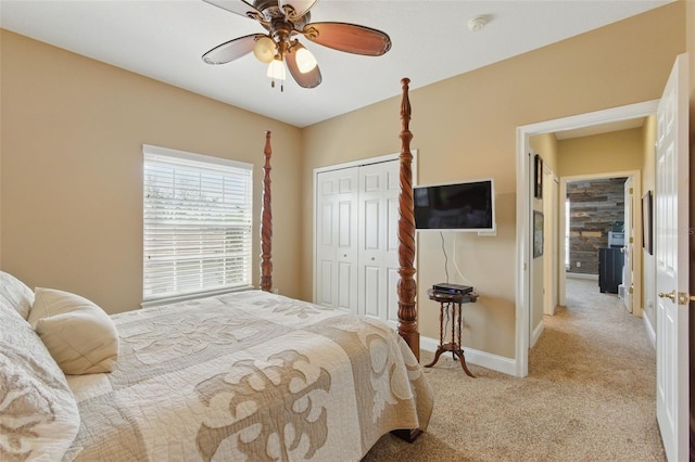 carpeted bedroom featuring ceiling fan and a closet