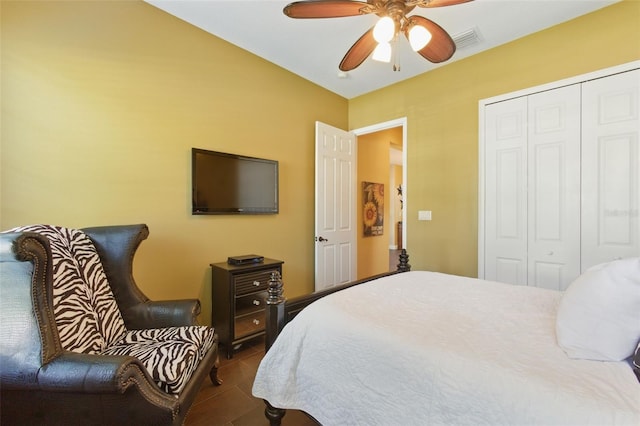 bedroom featuring tile patterned flooring, ceiling fan, and a closet