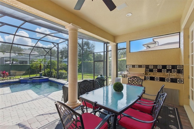 exterior space with ceiling fan and decorative columns