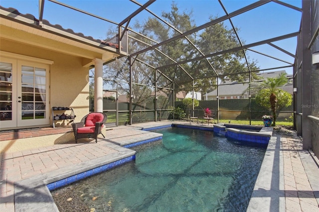 view of swimming pool with a patio, an in ground hot tub, glass enclosure, and french doors