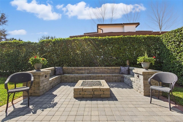 view of patio / terrace featuring an outdoor fire pit