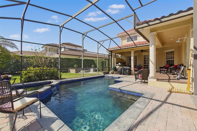 view of swimming pool featuring a patio, a lanai, and ceiling fan