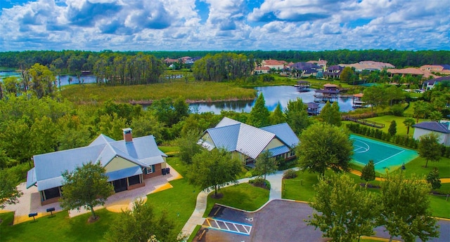 drone / aerial view with a water view and a residential view
