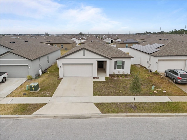 single story home with a garage and a front lawn