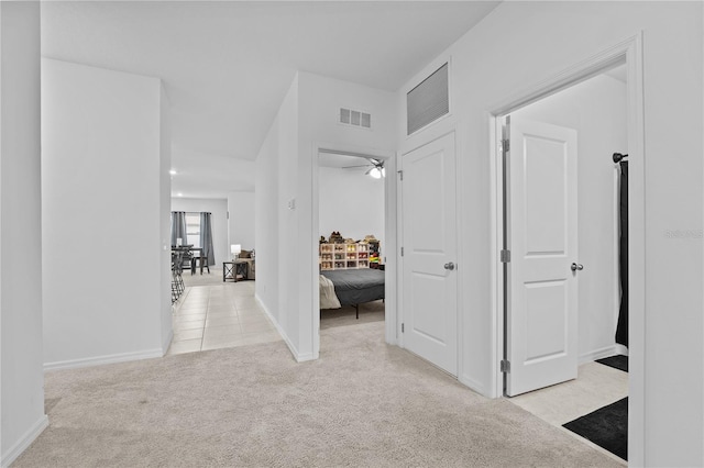 corridor featuring light colored carpet