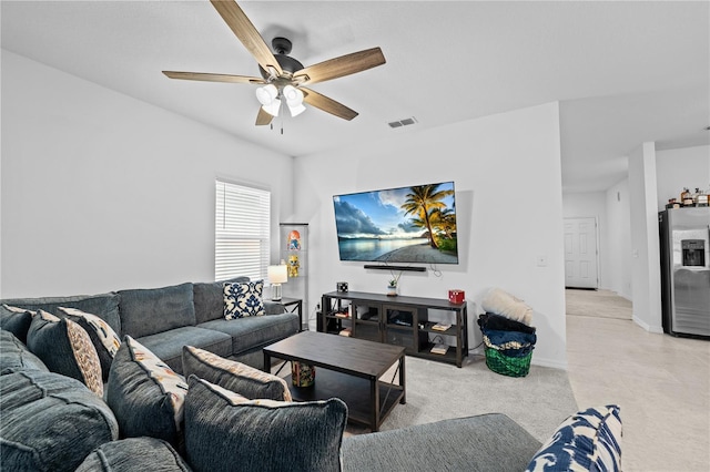 carpeted living room with ceiling fan