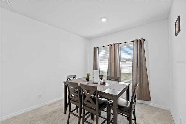 dining area featuring light colored carpet