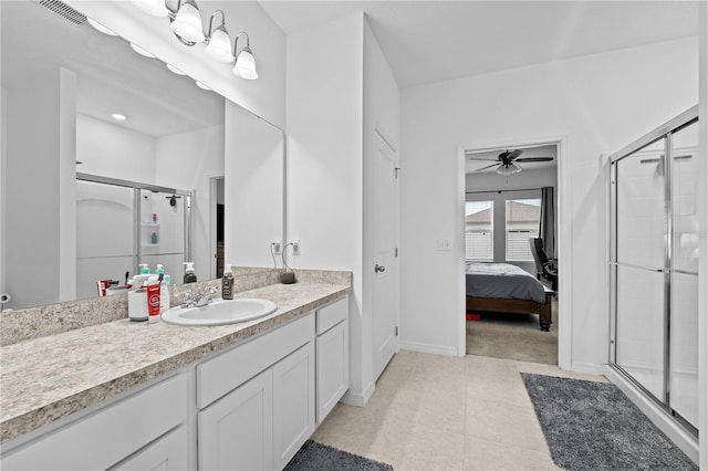 bathroom featuring ceiling fan, tile patterned floors, a shower with shower door, and vanity