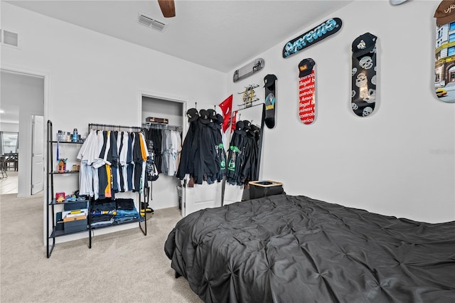 bedroom with carpet floors, ceiling fan, and a closet