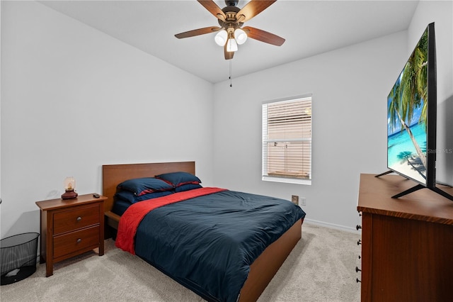 bedroom with ceiling fan and light carpet