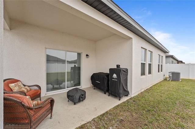 exterior space featuring central AC, a patio area, and a lawn