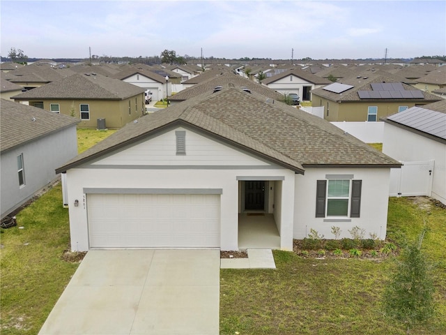 5861 Bar Ranch Rd, Saint Cloud, FL 34771 - view of front facade featuring a residential view, a garage, driveway, a shingled roof, and a front lawn