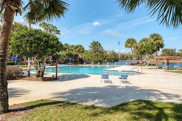 view of swimming pool featuring a pergola, a patio, and a water view