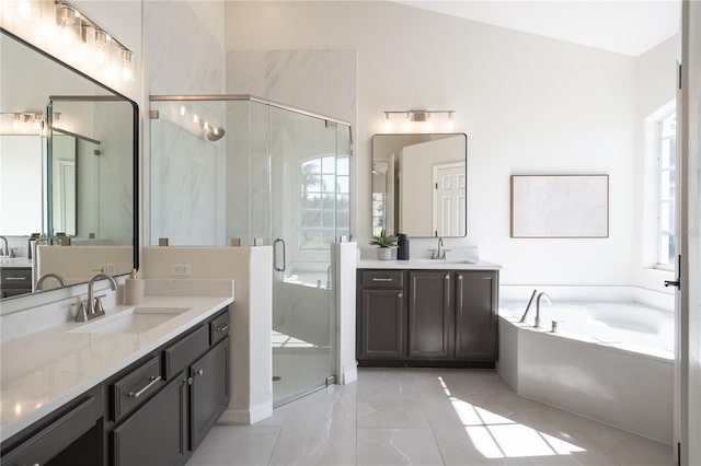 bathroom with vanity and shower with separate bathtub