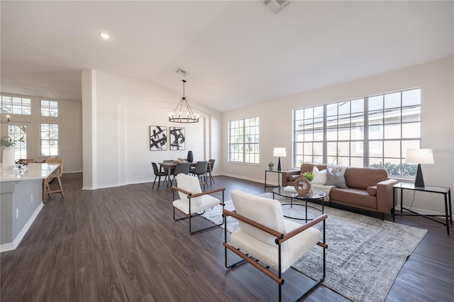 living room with vaulted ceiling, dark hardwood / wood-style floors, and a chandelier