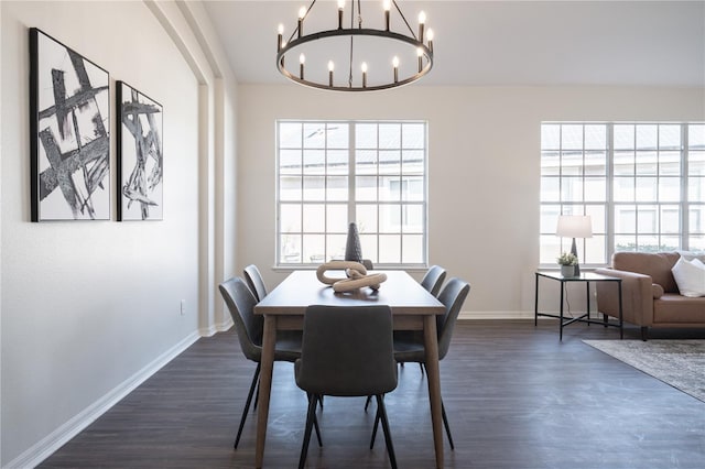 dining room featuring an inviting chandelier and dark hardwood / wood-style flooring