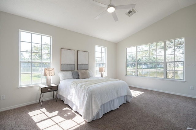 carpeted bedroom featuring multiple windows, vaulted ceiling, and ceiling fan